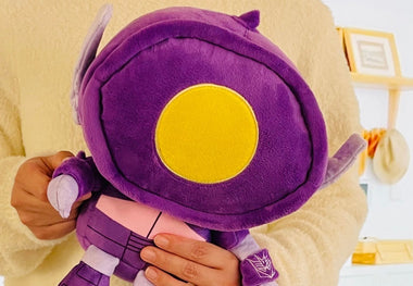 Load image into Gallery viewer, Purple plush toy with a yellow center held by a person against a neutral background