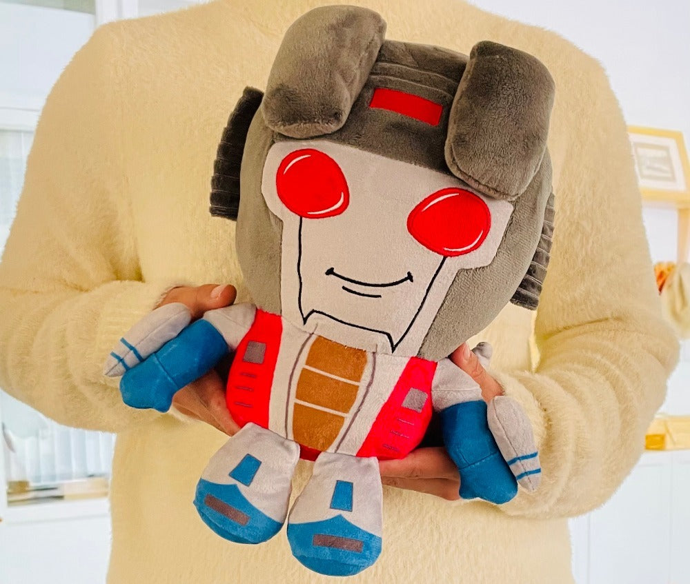 Person holding a robot plush toy with a neutral background