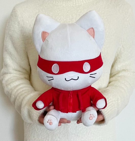 White plush toy cat with red outfit on a white background