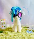 Load image into Gallery viewer, Plush toy with blue hair and goggles on a grassy area with a blurred background