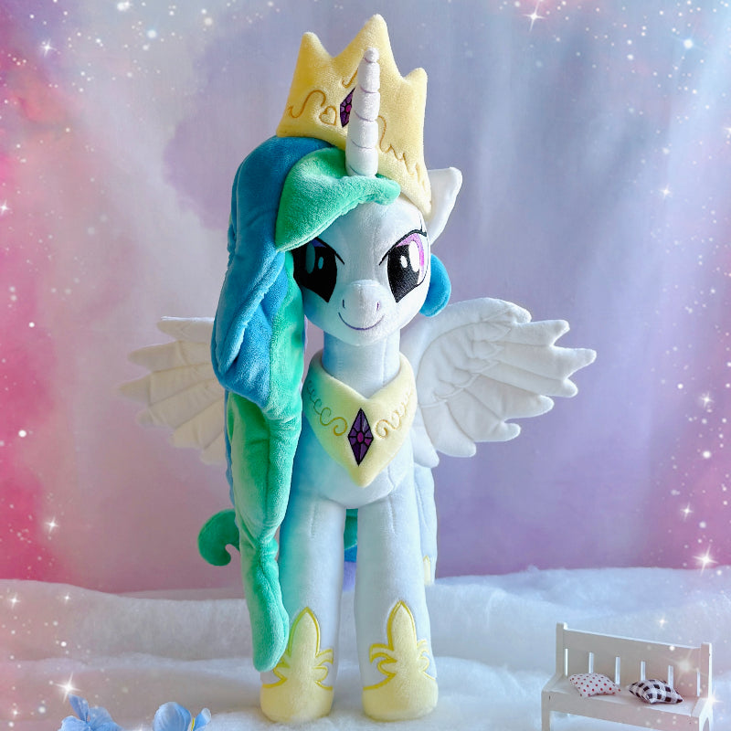 Plush toy of a character with wings and a crown against a soft, blurred background