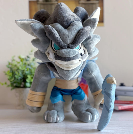 Plush toy of a wolf-like creature with blue eyes on a surface.
