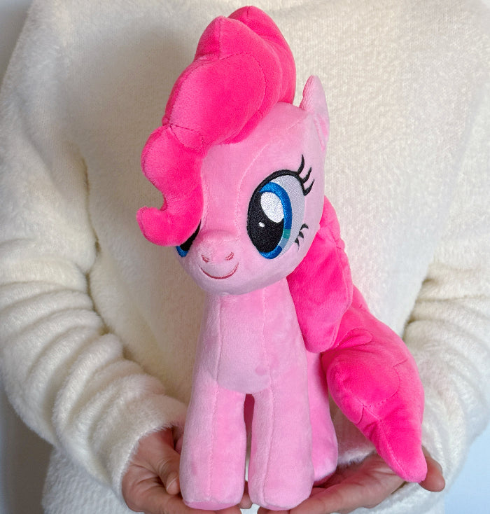 Pink plush toy with a white background