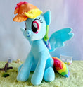 Load image into Gallery viewer, Plush toy of a blue pony with rainbow hair on a green surface