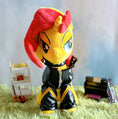 Load image into Gallery viewer, Plush toy with yellow face and red hair on a green surface with a blurred background