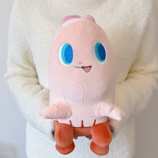 Plush toy with a cute design held by a person wearing a white sweater.