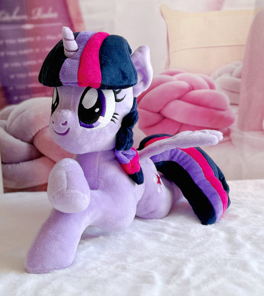 Plush toy resembling a character with purple hair and outfit on a white surface.