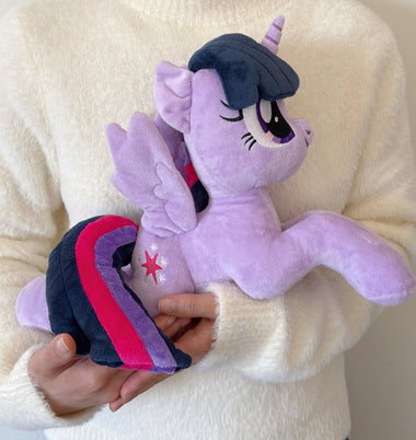 Load image into Gallery viewer, Purple unicorn plush toy held by a person wearing a white sweater.