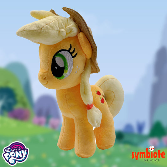 Plush toy of a pony with a straw hat against a blurred outdoor background, featuring 'My Little Pony' and 'Symbiote Studios' logos.