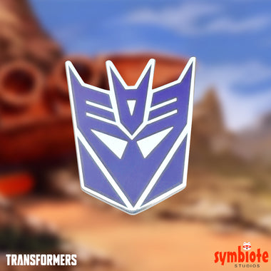 Load image into Gallery viewer, Transformers Decepticon Logo Pin, an officially licensed enamel pin of the Decepticon emblem, sold by Symbiote Studios.