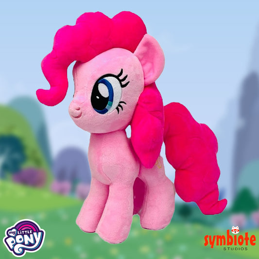 Plush toy of a pink pony with a blurred outdoor background