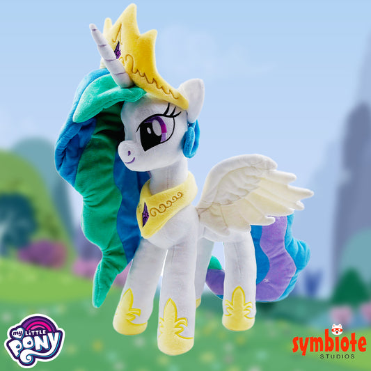 Plush toy of a unicorn with colorful mane and wings against a blurred outdoor background, featuring 'My Little Pony' and 'symbiote STUDIOS' logos.
