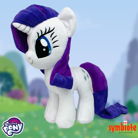 Plush toy resembling a pony with purple hair and tail, set against a blurred outdoor background.