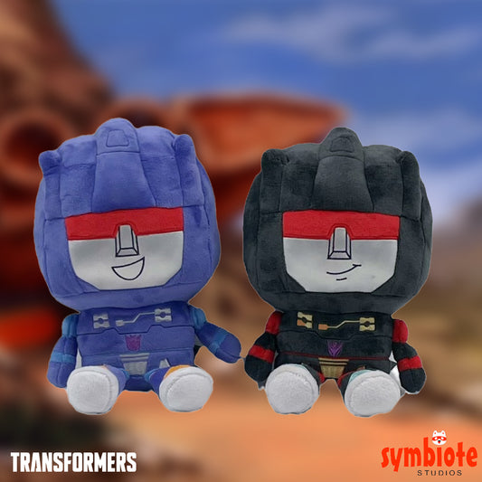 Two plush toys resembling characters from 'Transformers' with a blurred background.