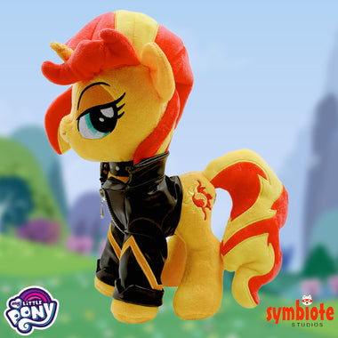 Load image into Gallery viewer, Plush toy of a pony character with red and yellow hair, wearing a black leather outfit, against a blurred outdoor background.