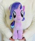 Load image into Gallery viewer, Plush toy unicorn held by a person wearing a white sweater
