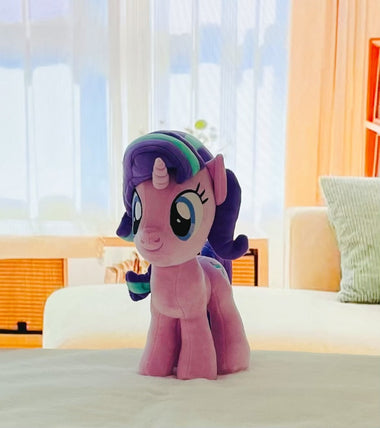 Load image into Gallery viewer, Plush toy resembling a character from 'My Little Pony' on a bed with a blurred room background
