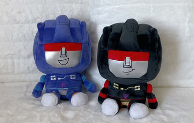 Load image into Gallery viewer, Two robot-themed plush toys, one blue and one black, sitting side by side on a textured white background.
