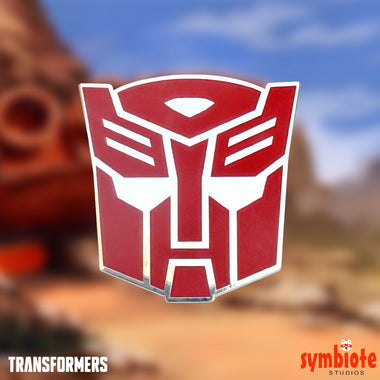 Load image into Gallery viewer, Transformers Autobot Logo Pin, an officially licensed enamel pin of the Autobot emblem, sold by Symbiote Studios.
