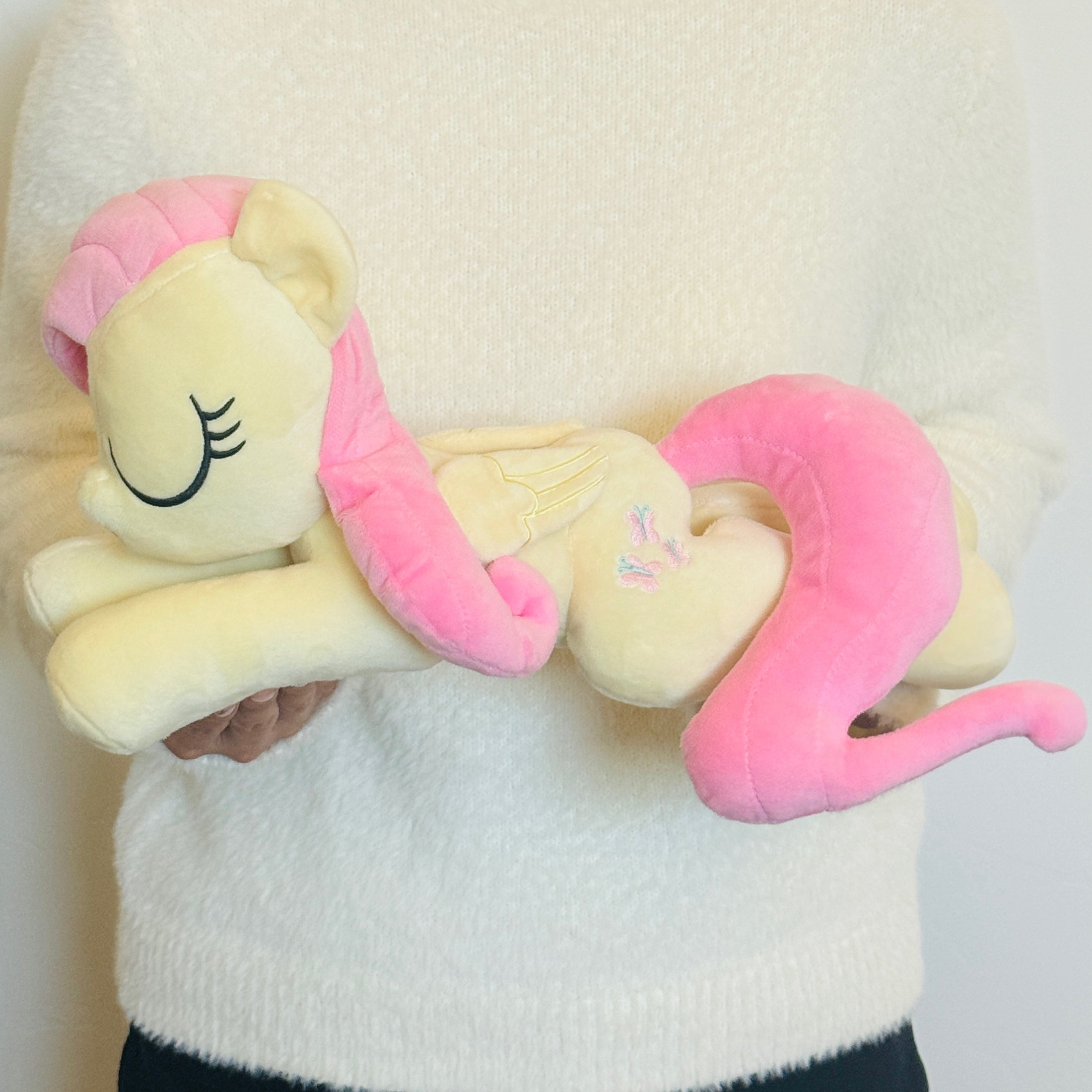 A sleepy-eyed officially licensed dream plush of Fluttershy. Pictured here is the My Little Pony Fluttershy Dream Plush. (IMG_0164.jpg)