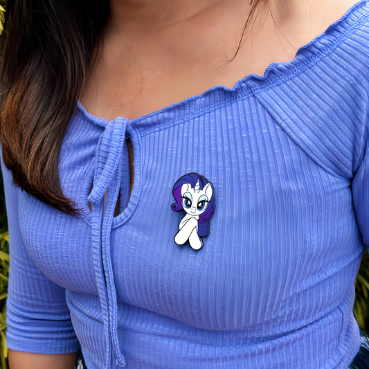 An officially licensed enamel pin of the fashionable unicorn Rarity. Pictured here is the My Little Pony Rarity Pin.