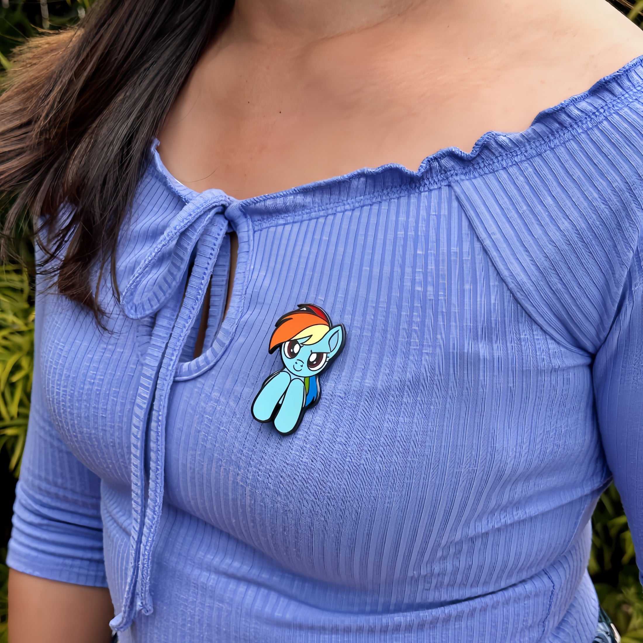 An officially licensed enamel pin of Rainbow Dash from My Little Pony. Pictured here is the My Little Pony Rainbow Dash Pin.