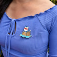 Load image into Gallery viewer, An enamel pin of Catnip Bravo floating on a barrel at sea. Pictured here is the Catnip Bravo Shipwrecked Pin.
