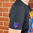 Load image into Gallery viewer, An officially licensed enamel pin of the Decepticon emblem. Pictured here is the Transformers Decepticon Logo Pin.
