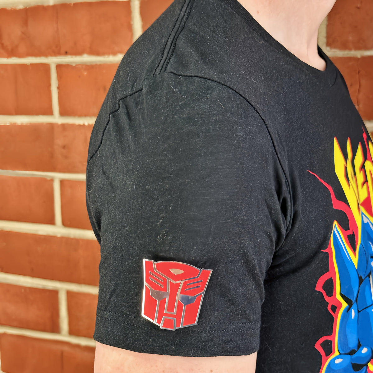 An officially licensed enamel pin of the Autobot emblem. Pictured here is the Transformers Autobot Logo Pin.